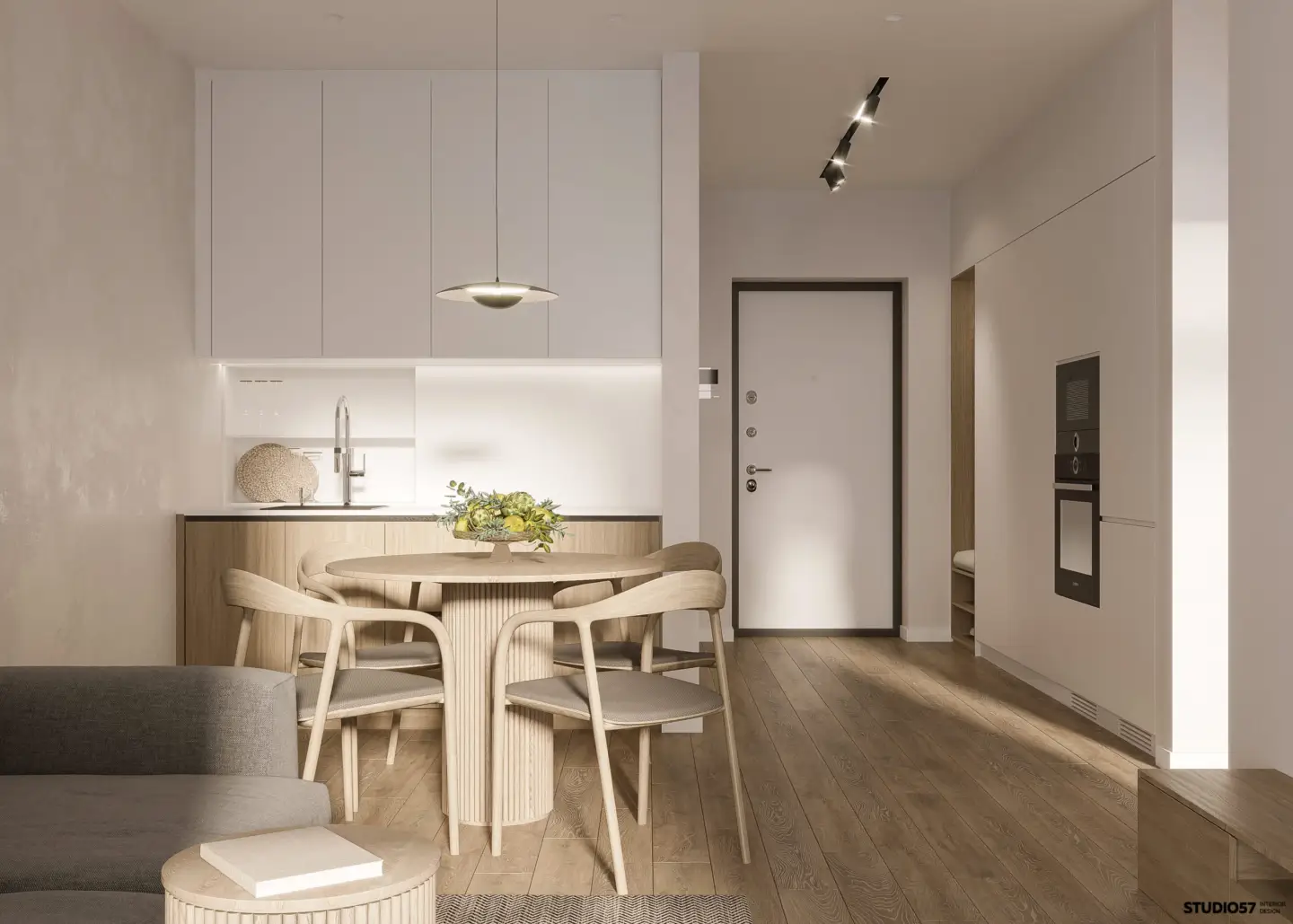 Apartment kitchen and dining area with a white entrance door and wood flooring