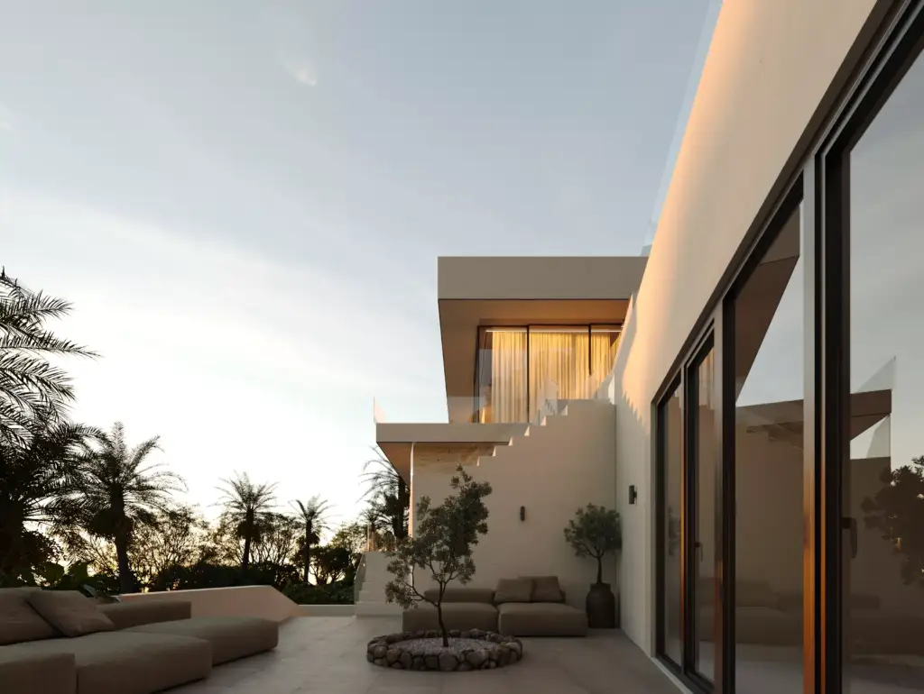 Casa moderna con zona de estar exterior al atardecer