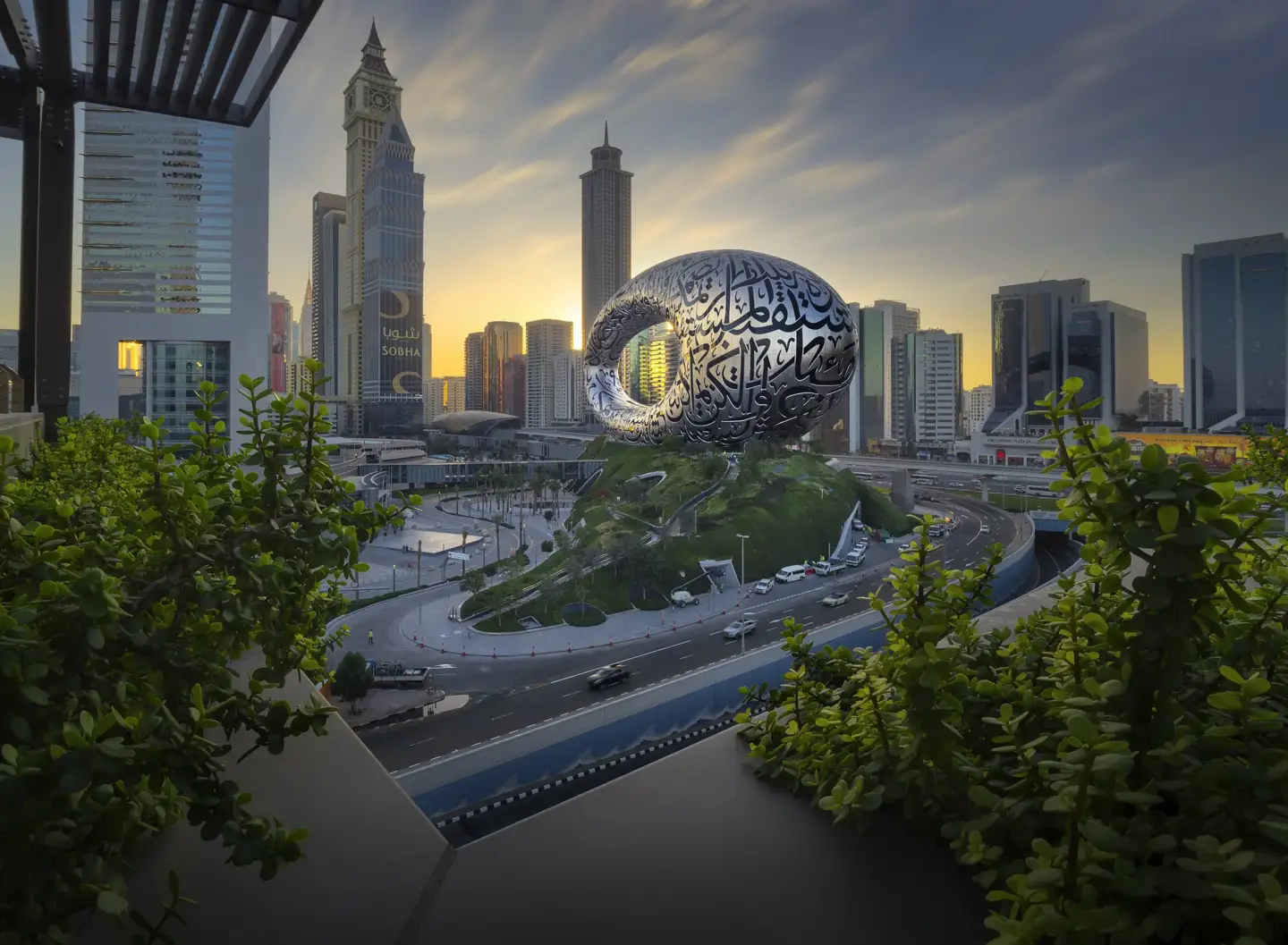 Museum of the Future in Dubai at sunset with skyline buildings and highway traffic