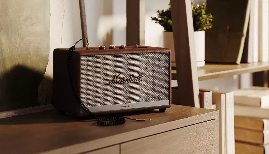 Render 3D de producto: altavoz Marshall sobre un mueble de madera junto a estanterías y libros en un interior cálido