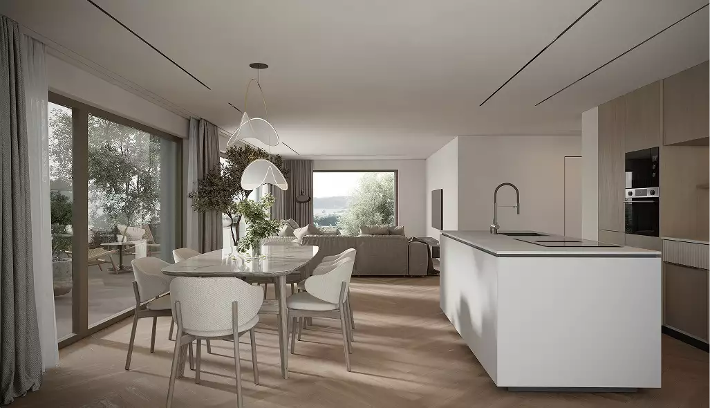 Eet- en keukenruimte in het appartementencomplex met grote ramen en minimalistisch meubilair