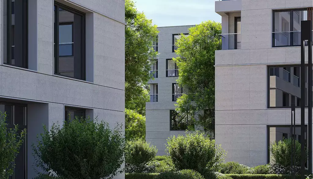 Moderne Wohngebäude einer Apartmentanlage mit begrüntem Innenhof, Bäumen und großen Fenstern