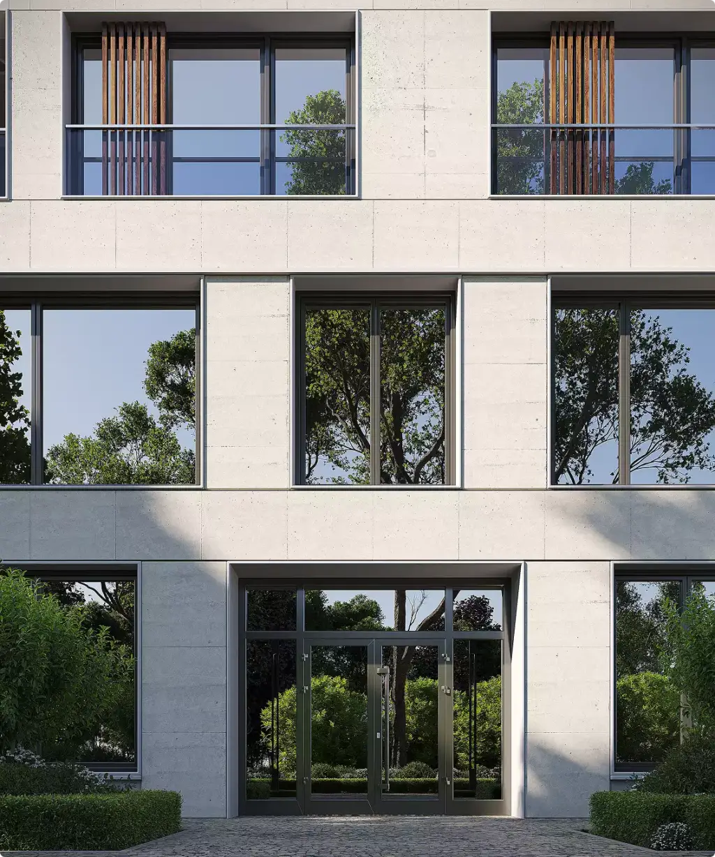 Gevel van het appartementengebouw met grote ramen, balkons en aangelegde entree