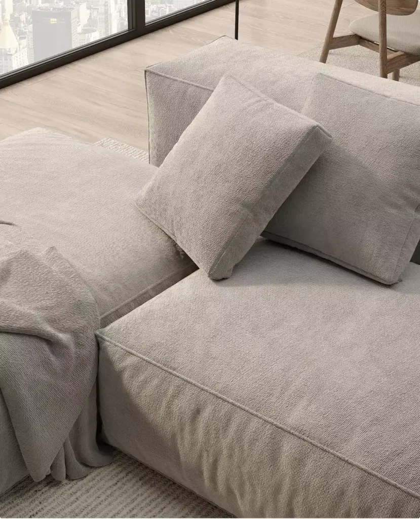 Dettaglio di un divano modulare, rendering 3D di arredo con rivestimento grigio morbido, cuscini e tessuto drappeggiato