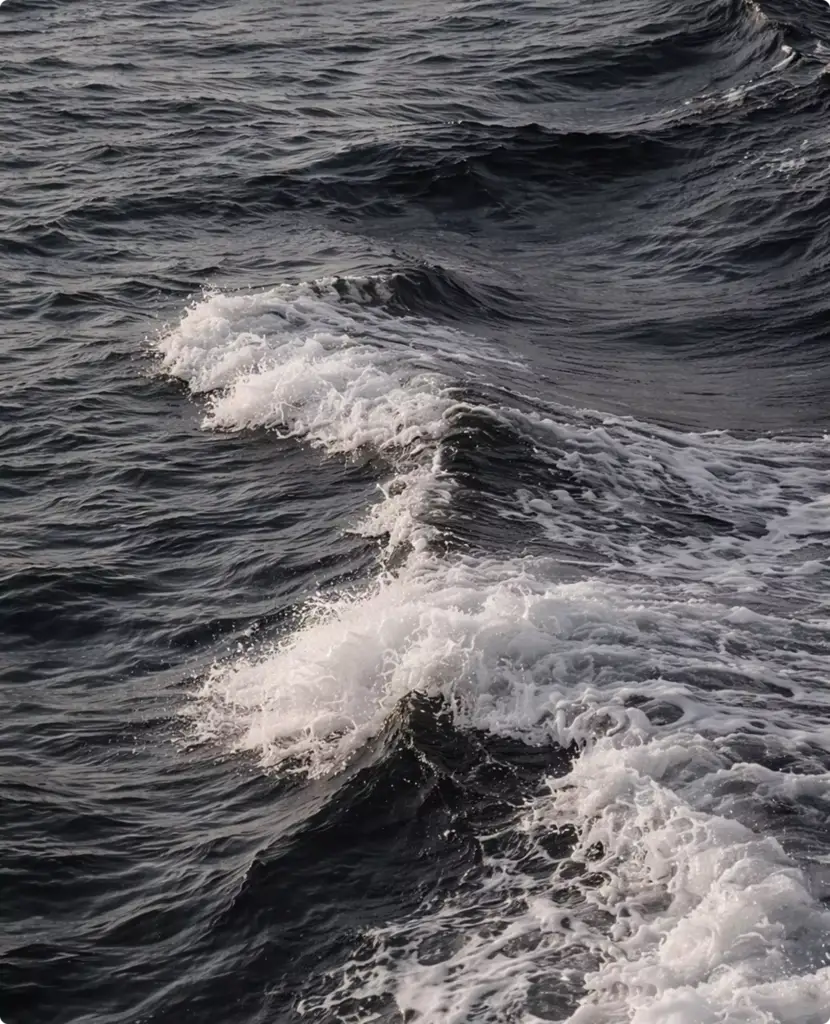 Churning ocean wake behind unseen yacht rendering with layered dark waves and foaming white crests