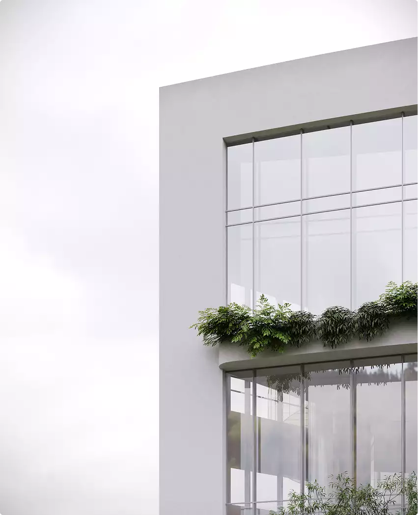 Hoek van de glazen gevel met beplante terrasrand en wit kader