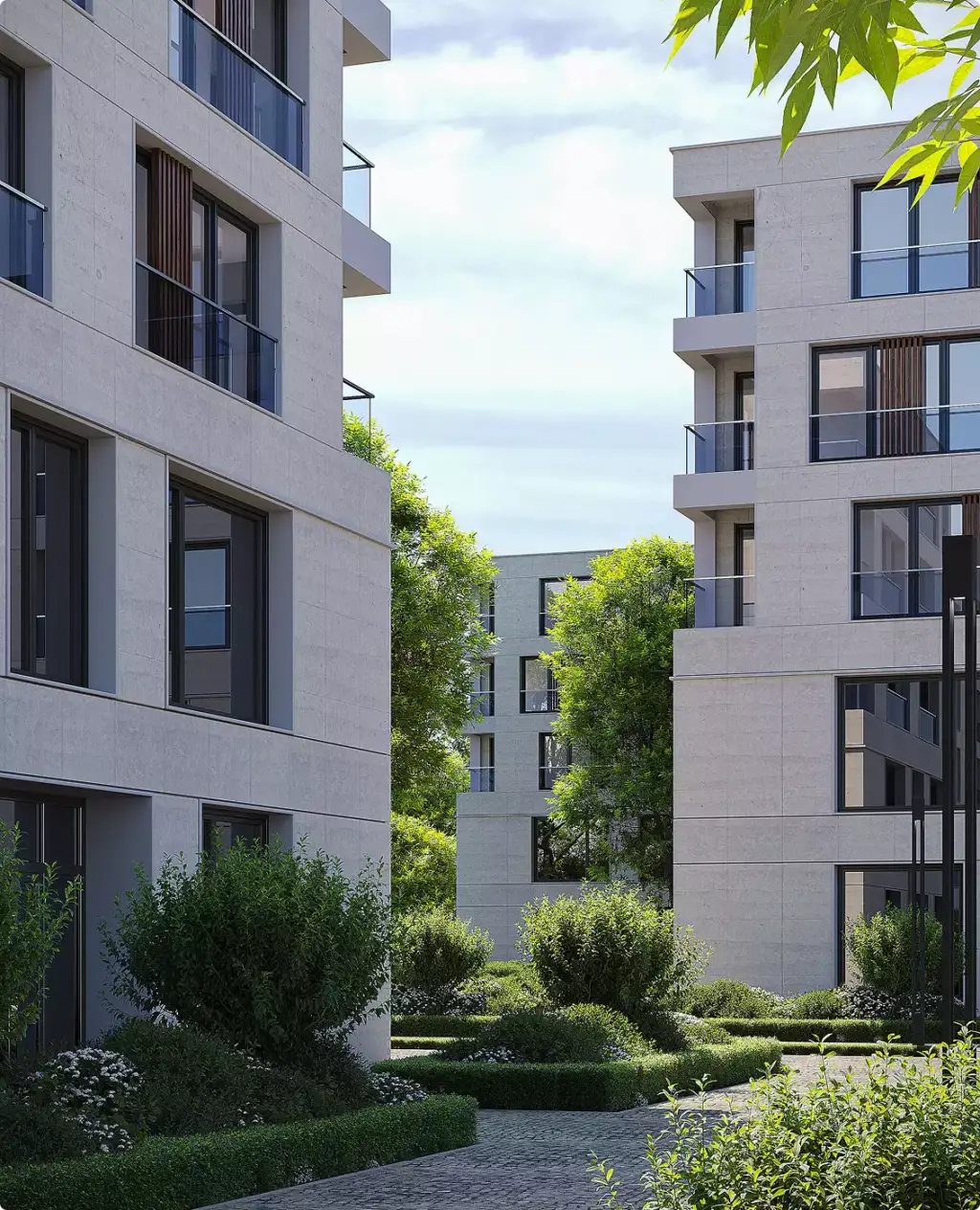 Appartementengebouwen met balkons rond een aangelegde binnentuin met bomen
