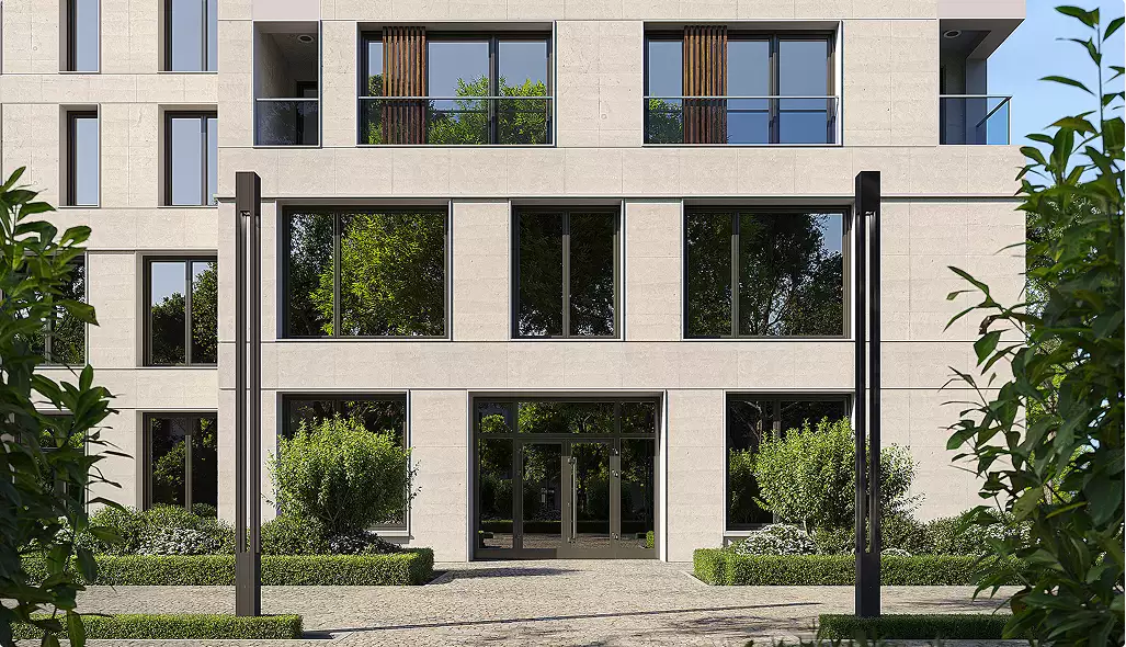 Gevel van het appartementencomplex met balkons, grote ramen en aangelegde entree