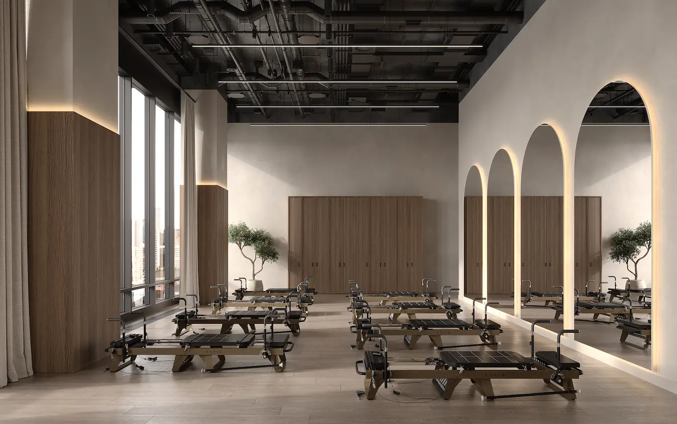 Pilates studio with reformers, tall windows, and arched mirrors, 3D rendering outsourcing