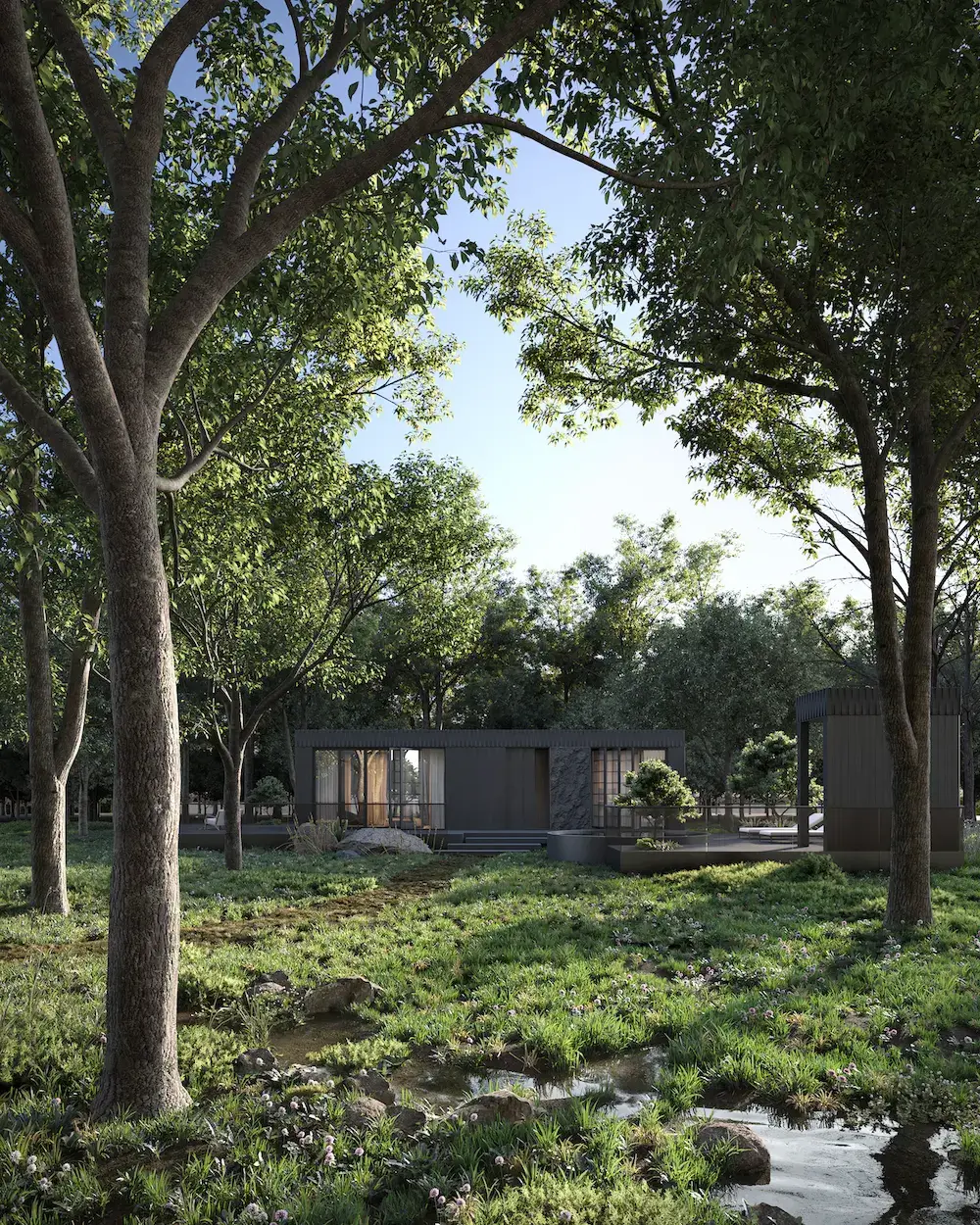 Render van een lage prefab woning met plat dak en donkere gevelbekleding tussen hoge loofbomen, met glazen puien, een natuurstenen gevelvlak en een terras aan een beekje, gezien vanaf een bemoste oever met stenen op de voorgrond