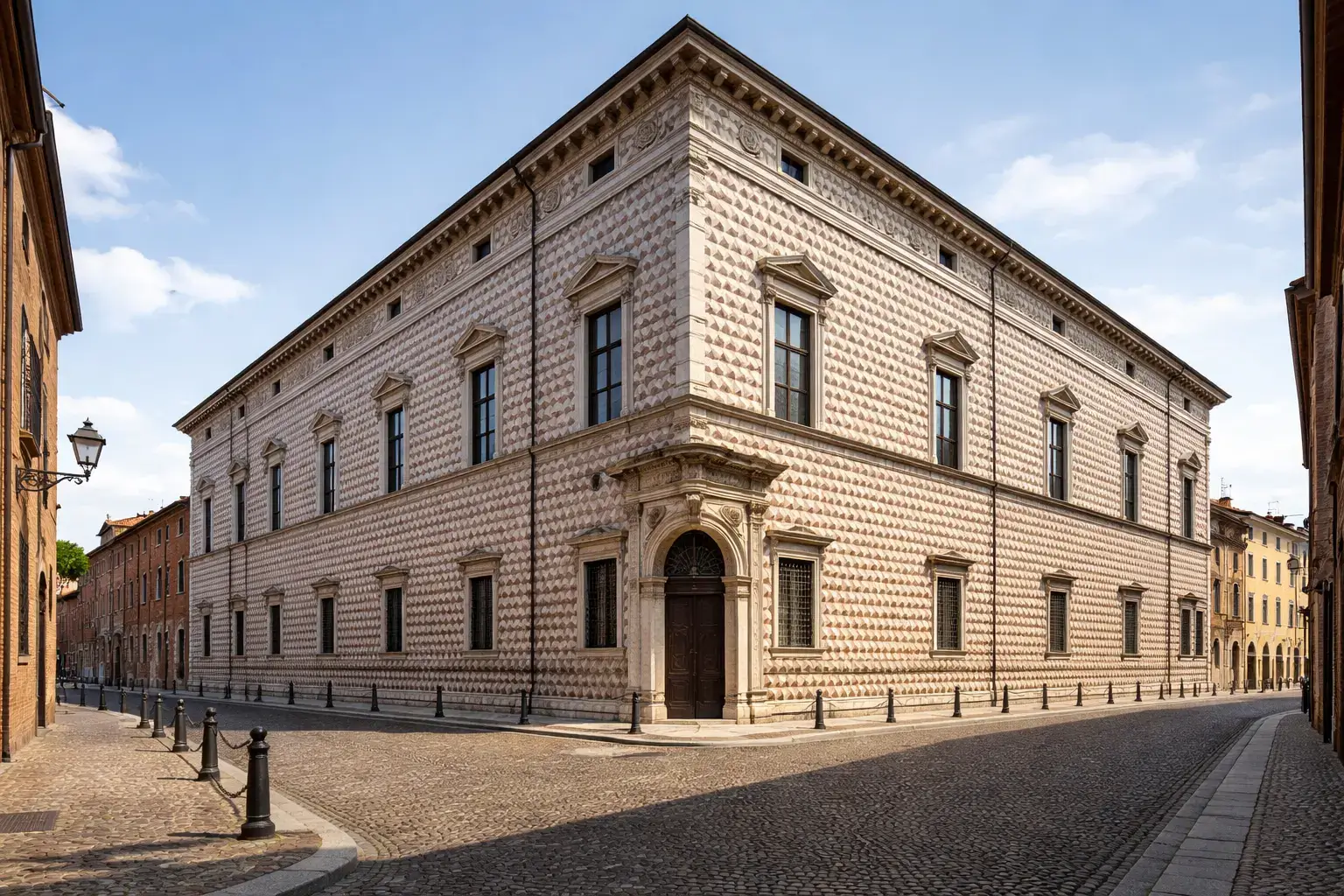 Corner view of a Renaissance palazzo with a rusticated stone facade and symmetrical windows