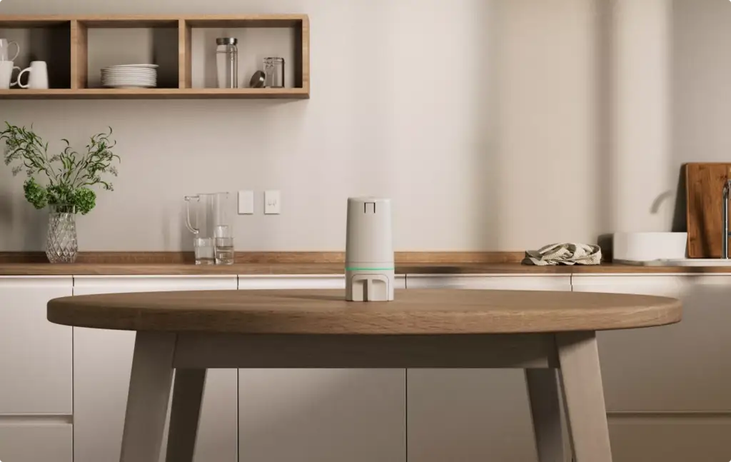 Render of a white smart pill dispenser on a kitchen table