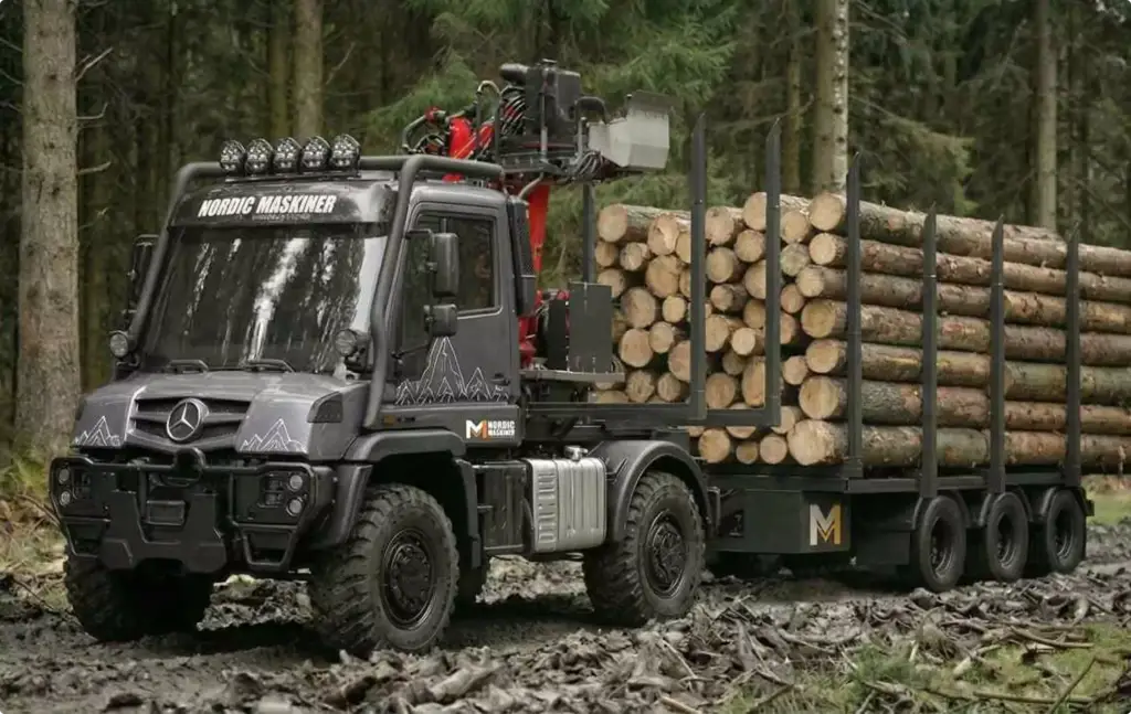 Forestry truck carrying logs on muddy forest road, Automotive Rendering Service