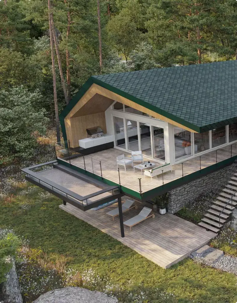 Vue extérieure d'un chalet moderne au toit vert, vaste terrasse en bois dominant un paysage boisé