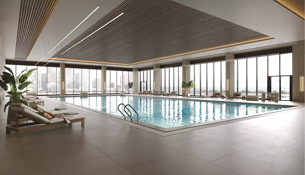 Piscina interna nell'interior design di un club fitness con lettini, grandi vetrate e acqua calma
