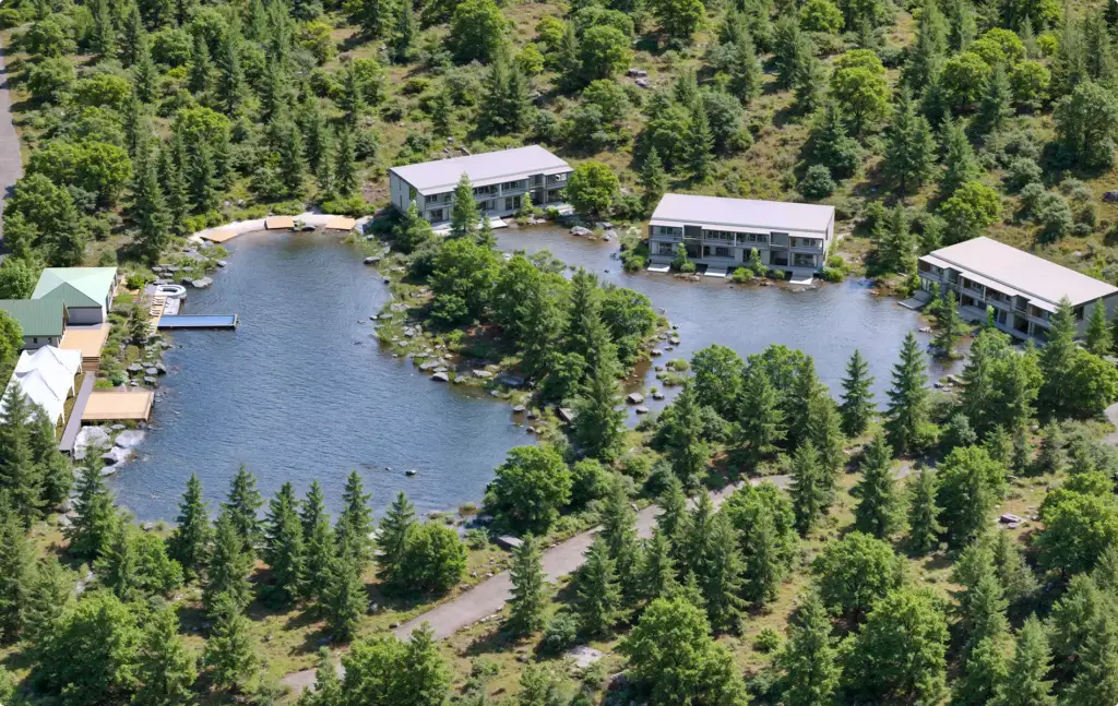 Landscape Rendering Services aerial view of lakeside cabins surrounded by dense green forest