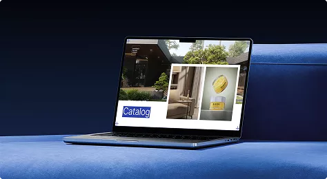 Laptop on surface showing catalog layout with interior and product images, menu pictures display