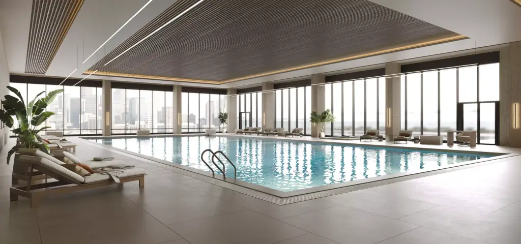 Render of a hotel indoor lap pool with loungers and floor-to-ceiling city views
