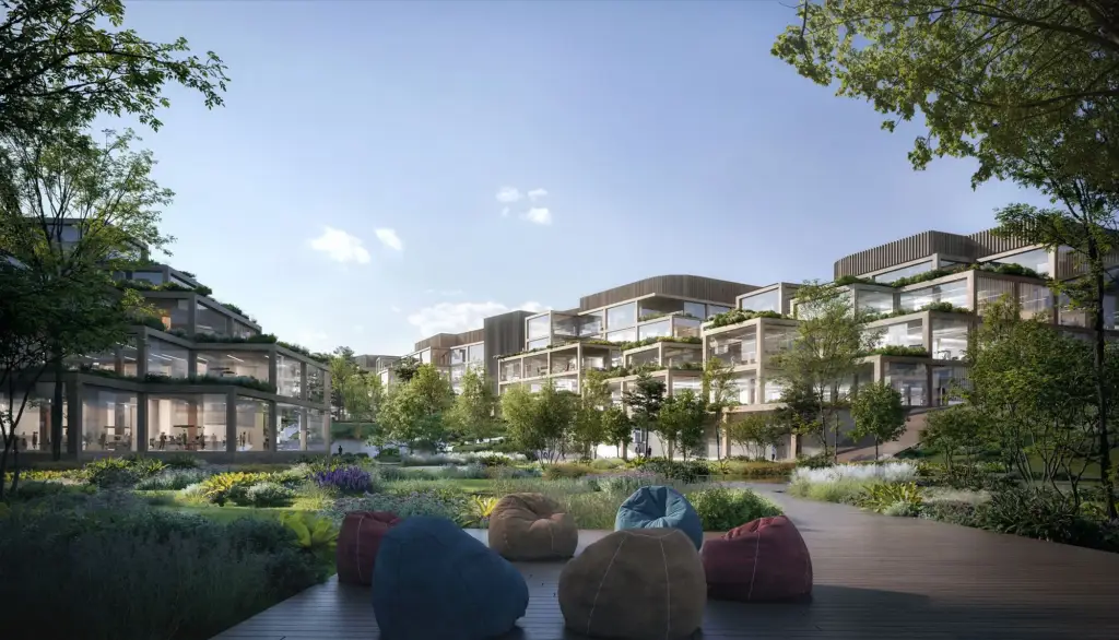Rendu de la cour d’un campus de bureaux avec des bâtiments en terrasses et un espace lounge