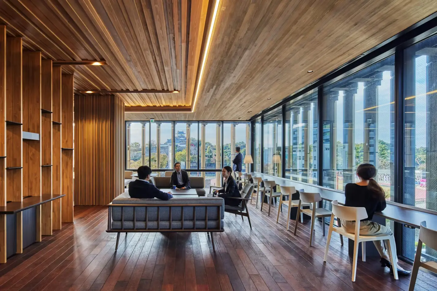 Best 3D Interior Rendering Companies in 2026 Modern office lounge with wood ceiling panels, large windows, and soft seating