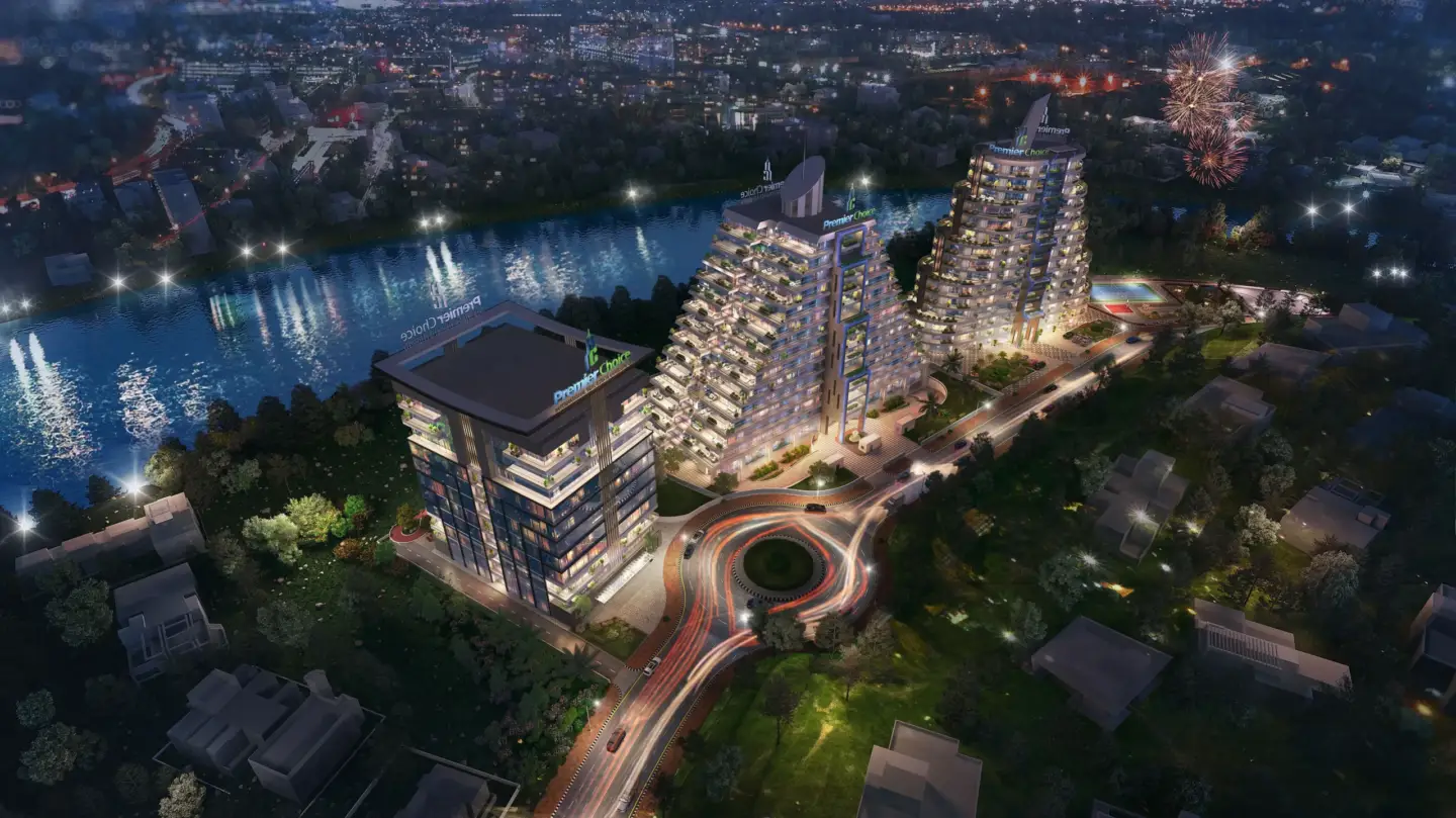 Night aerial of illuminated residential towers by river and roundabout, Best 3D Rendering Companies in Abu Dhabi for Real Estate & Architecture