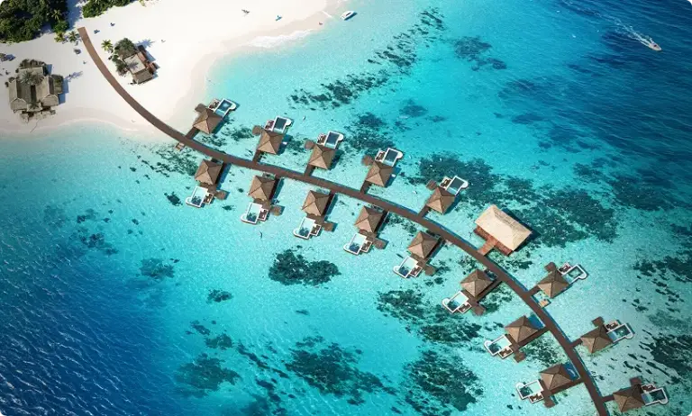 Tropical resort hero image with overwater villas and clear turquoise ocean aerial view