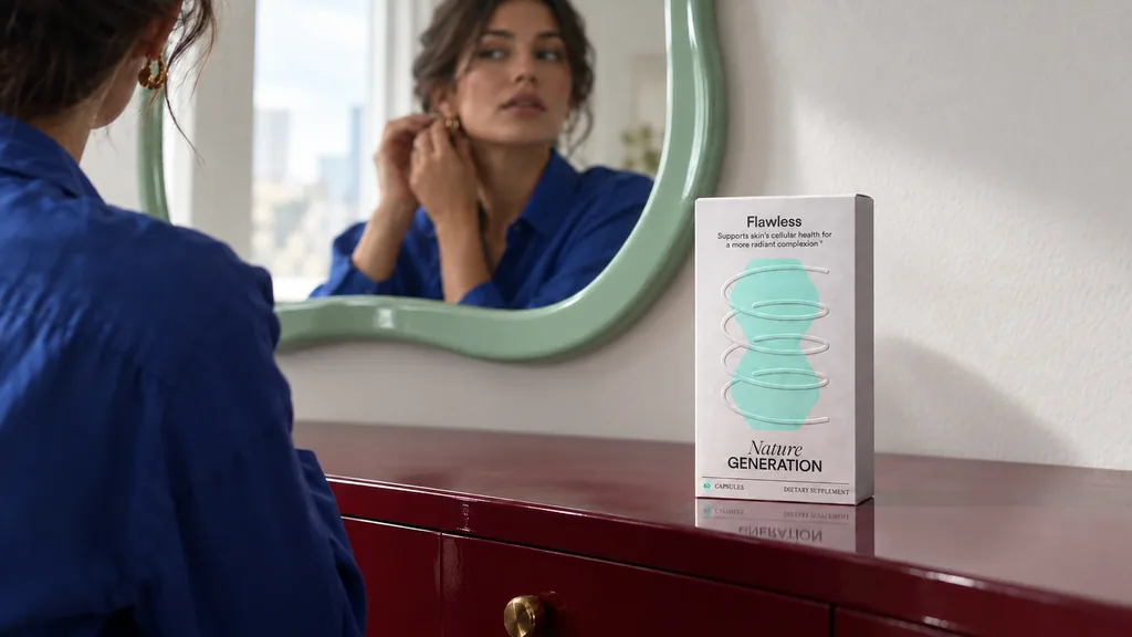 Lifestyle render of a Flawless supplement carton on a dresser while a woman puts on earrings in the mirror