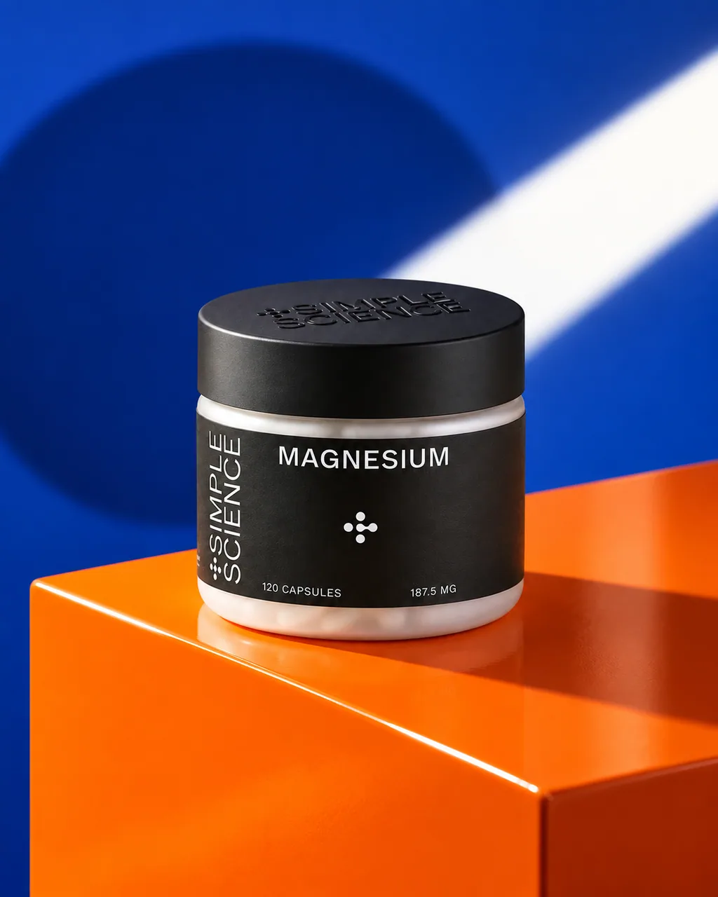 Simple Science magnesium jar on an orange block against a blue wall