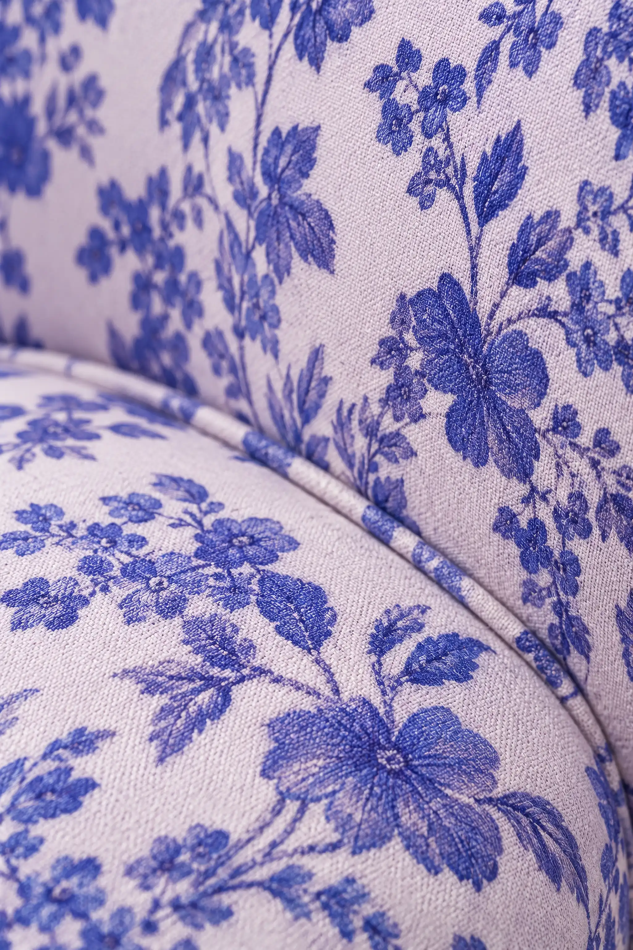 Close-up portrait render of a chair upholstered in white fabric with a blue floral print