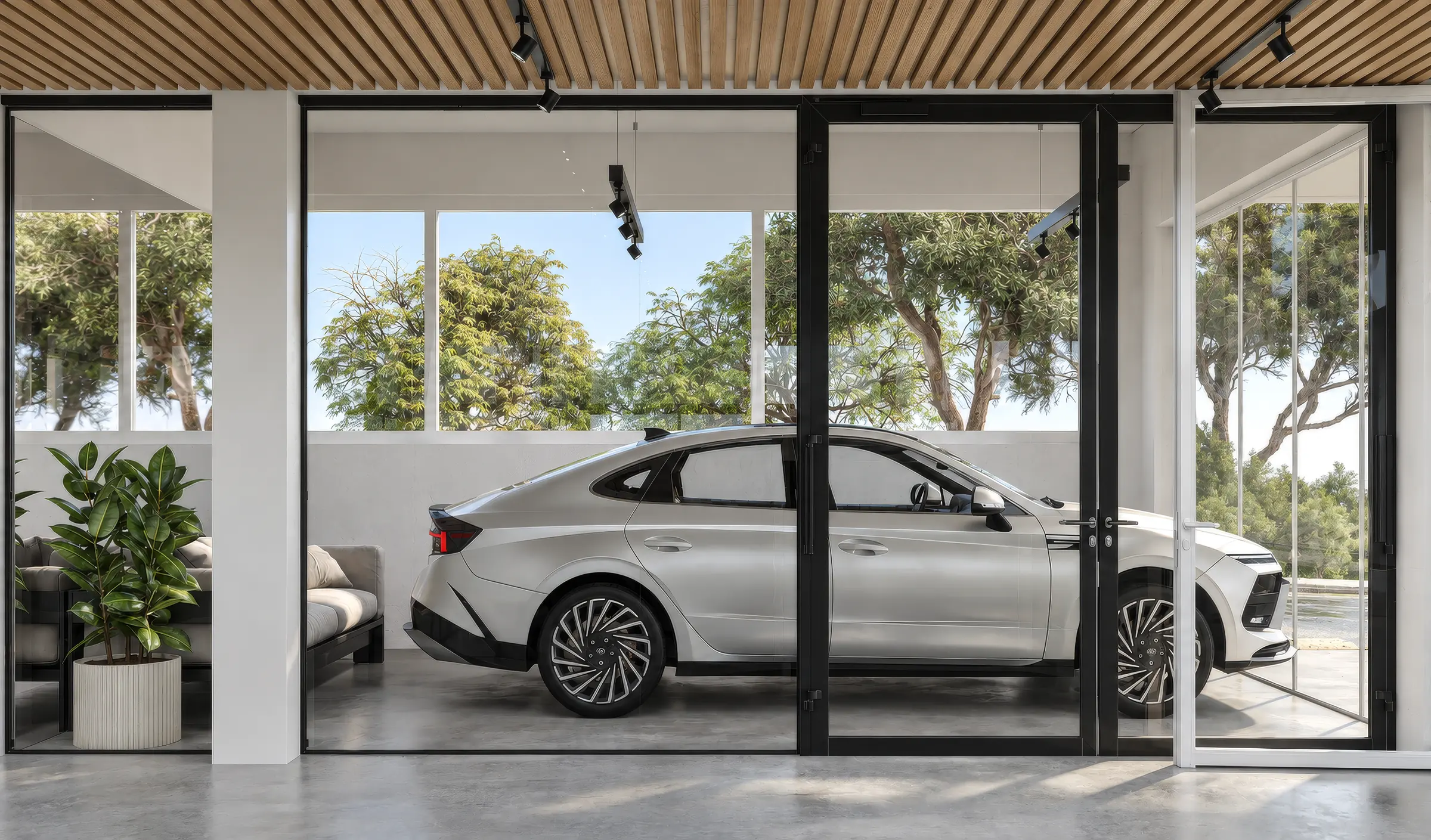 Rendering of a glazed display bay in a car showroom with a white sedan behind glass doors