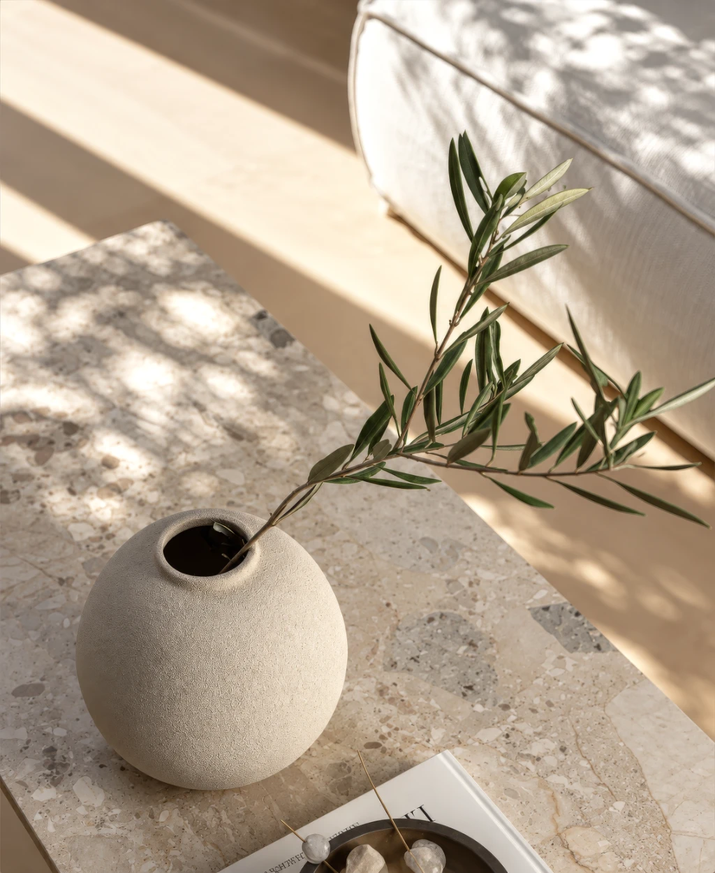 3D Animation of House That Helped Launch Sales Earlier 3D rendering of a beige vase with an olive branch on a marble tabletop in sunlight.