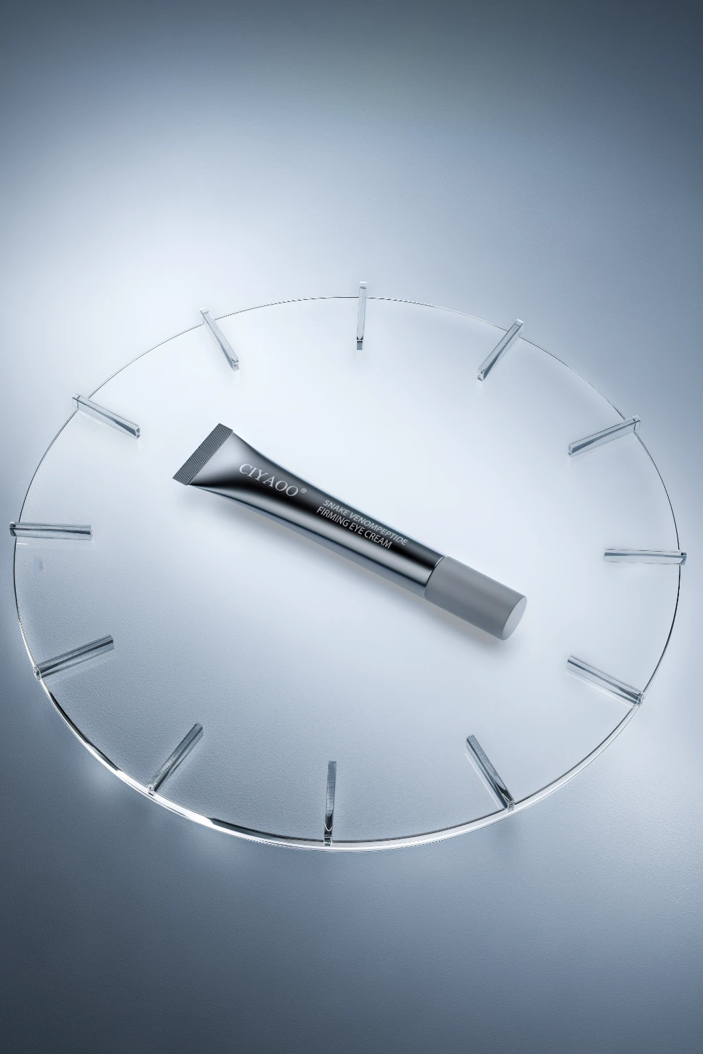 3D rendering of a black tube of eye cream on a clear clock face with silver details.