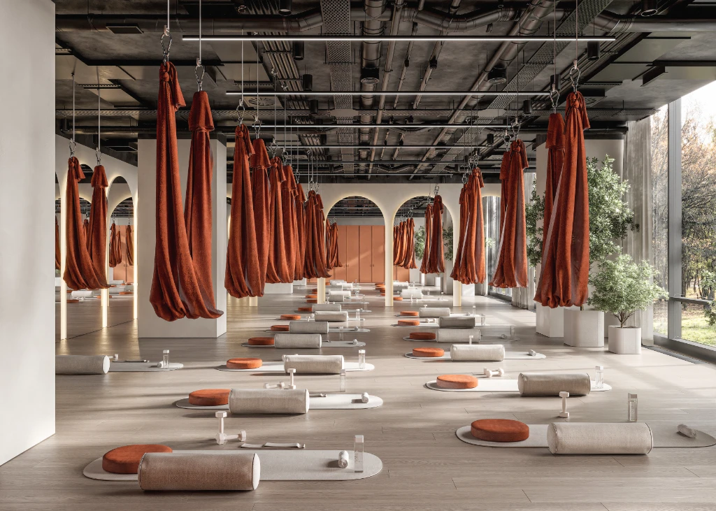 Rendu 3D d'un intérieur de salle de sport paisible avec hamacs de yoga aérien et décor minimaliste.
