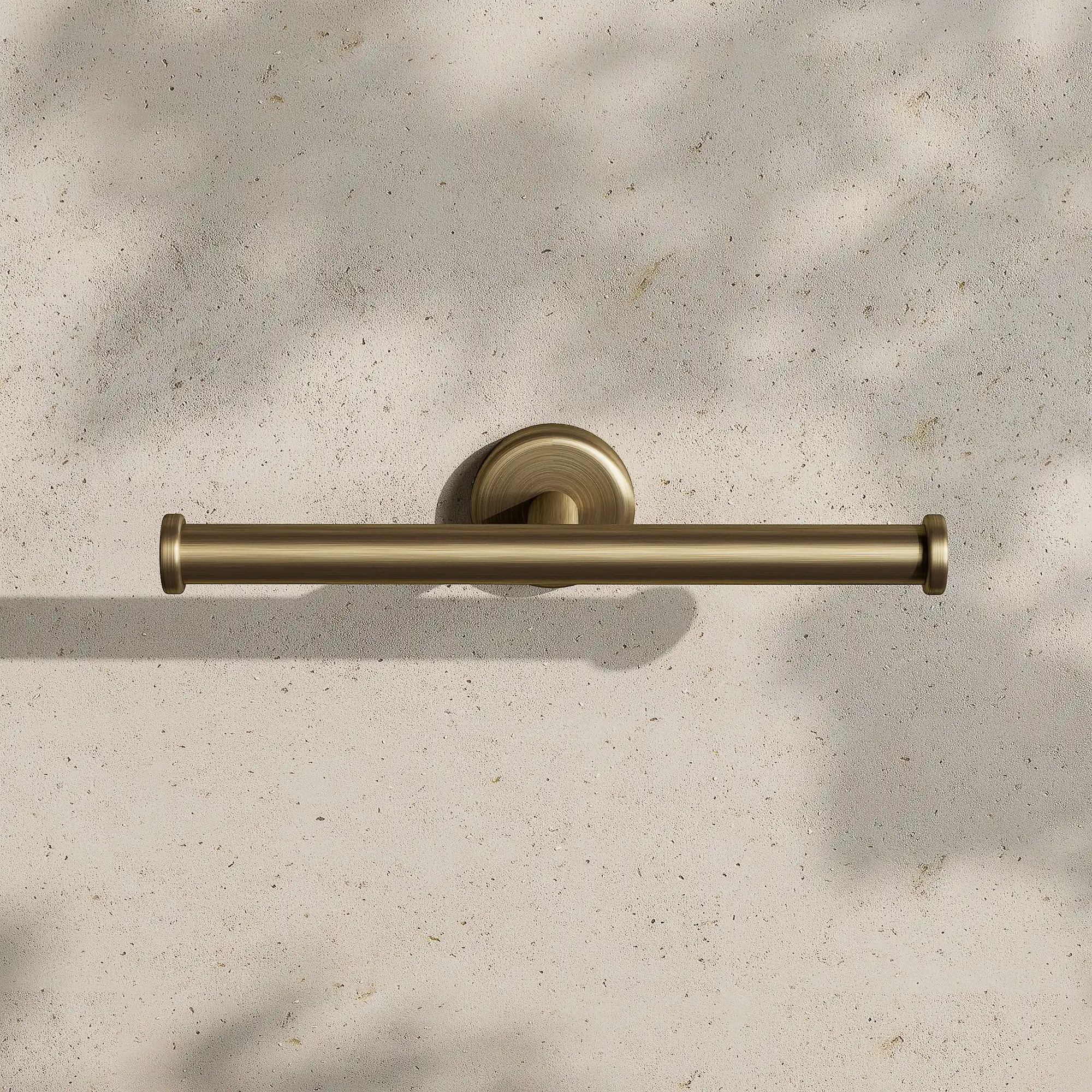 Render of a double toilet roll holder in antique brass on a stone wall