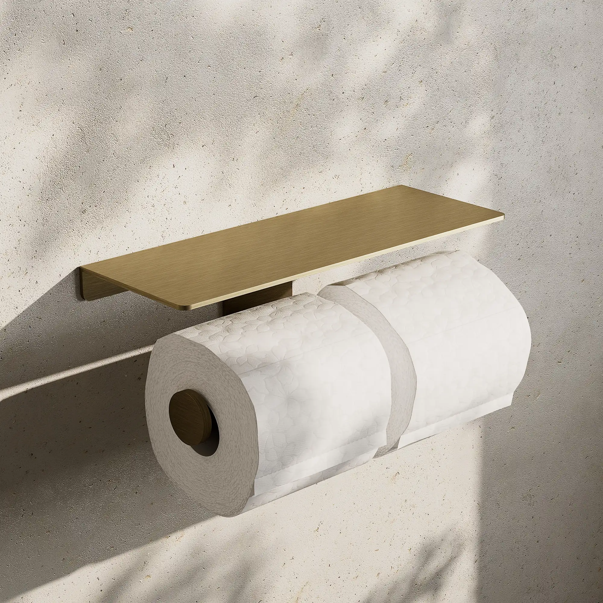 Render of a double toilet roll holder with a shelf in antique brass, with two rolls of paper, on a stone wall