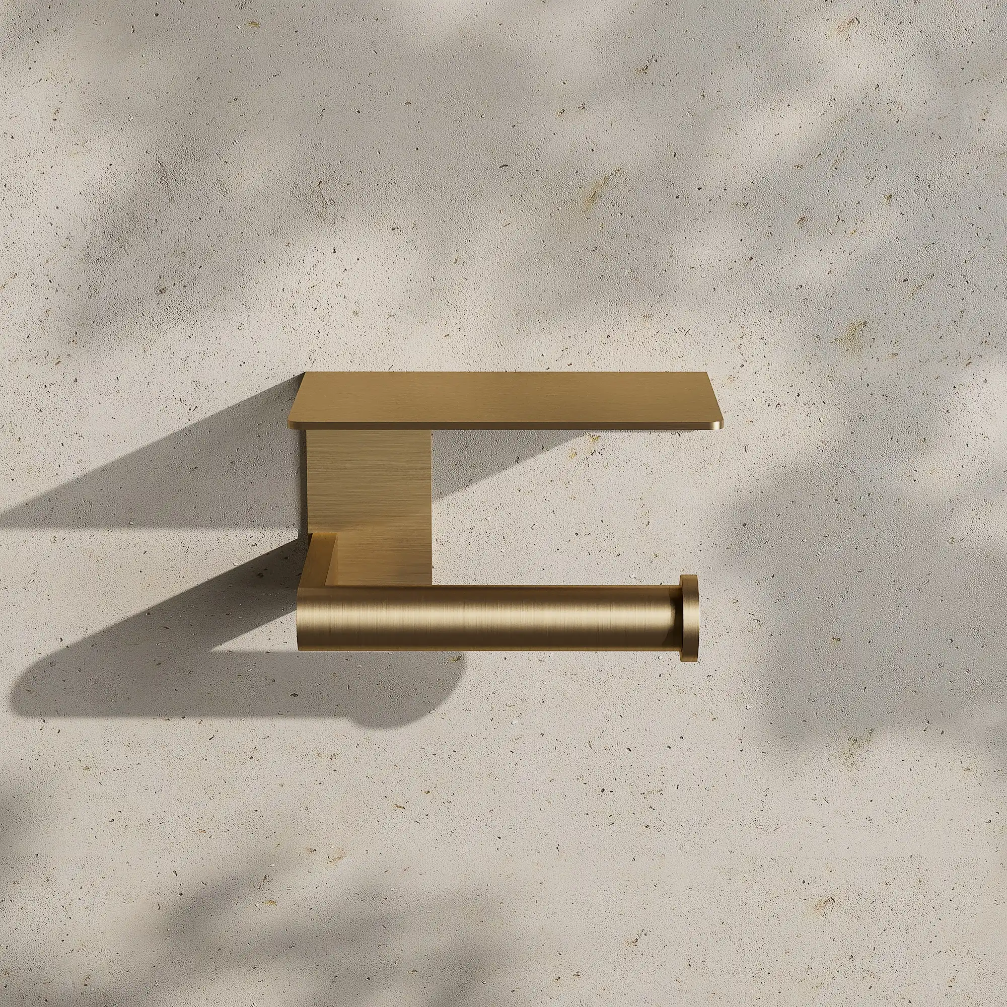 Render of a toilet roll holder with a shelf in brushed gold on a stone wall