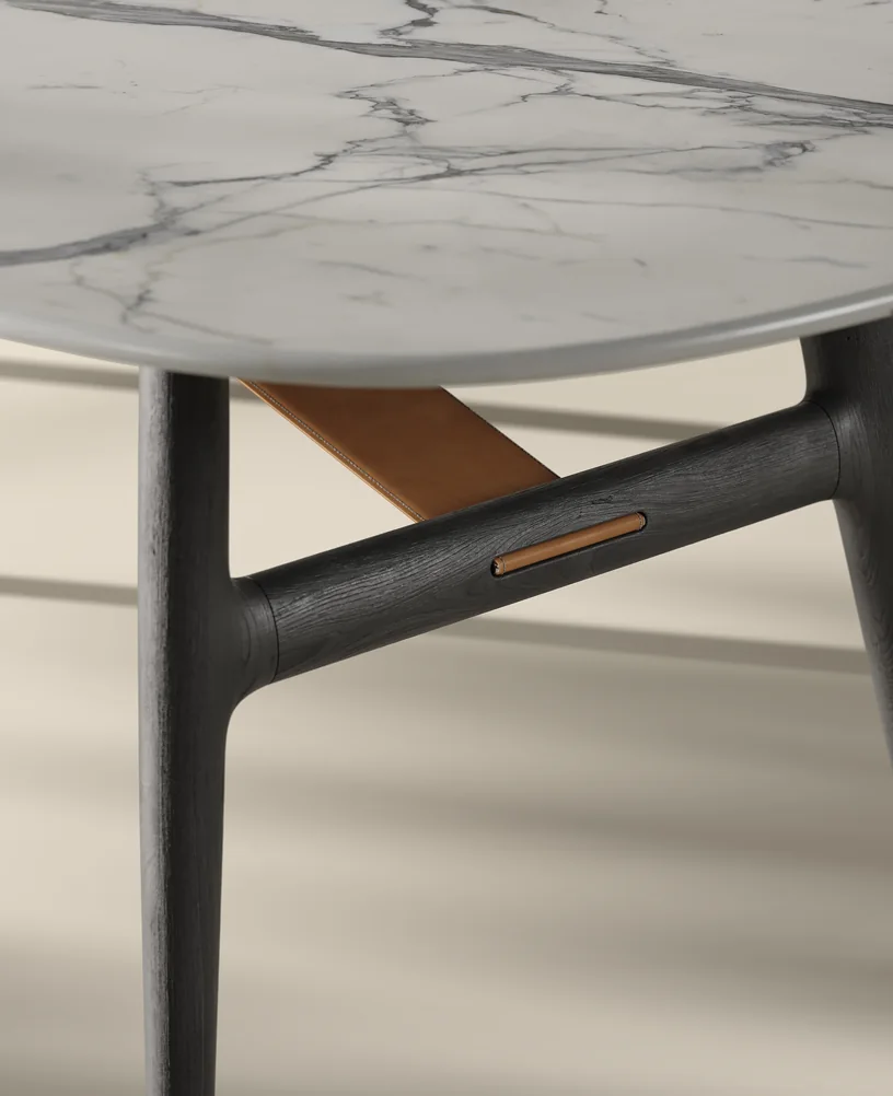Close-up render of a white marble table top with grey veining on a dark-stained wooden base with a tan brace