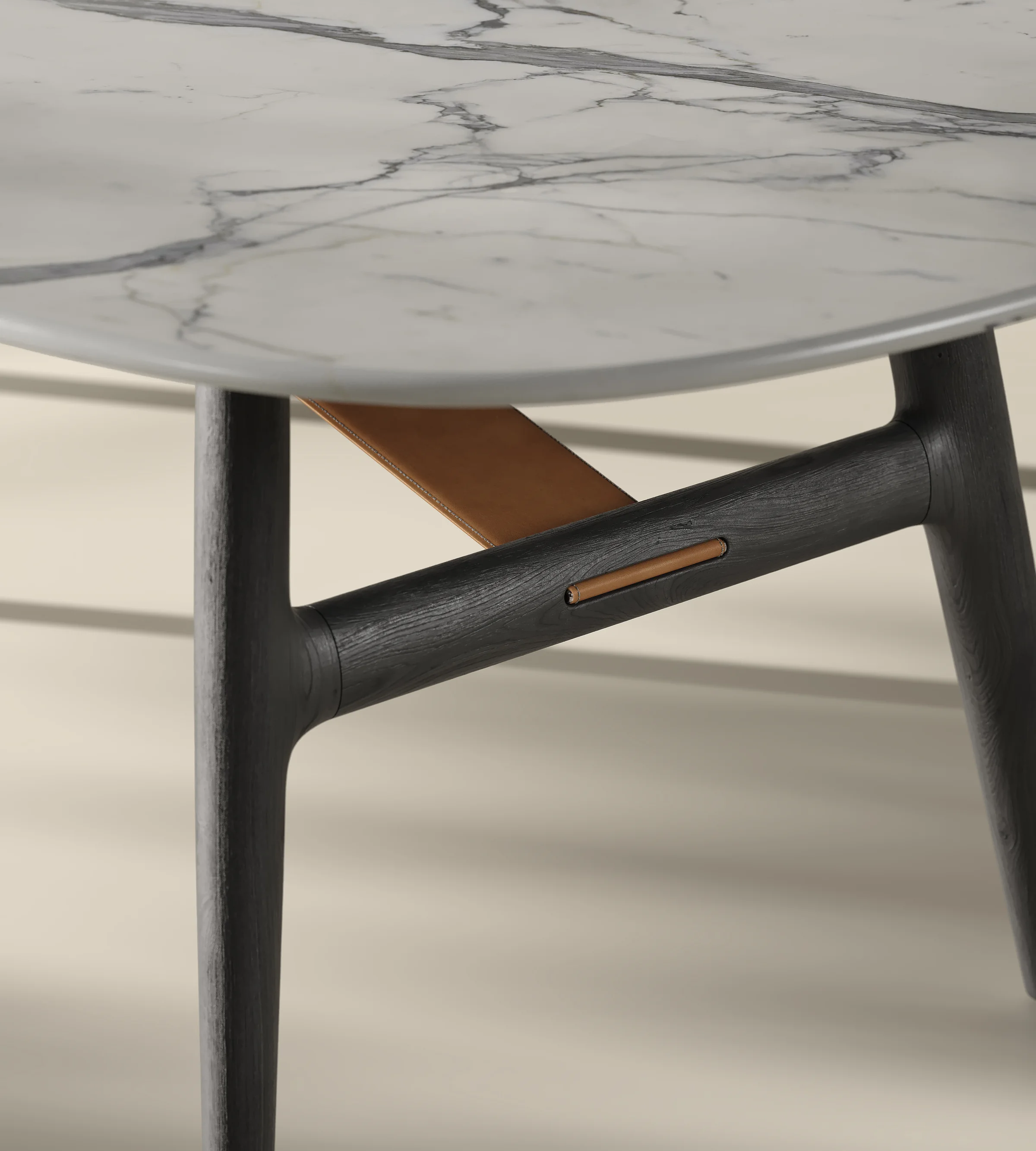 Close-up render of the dining table base with a dark wooden leg, a tan brace and a white marble top with grey veins