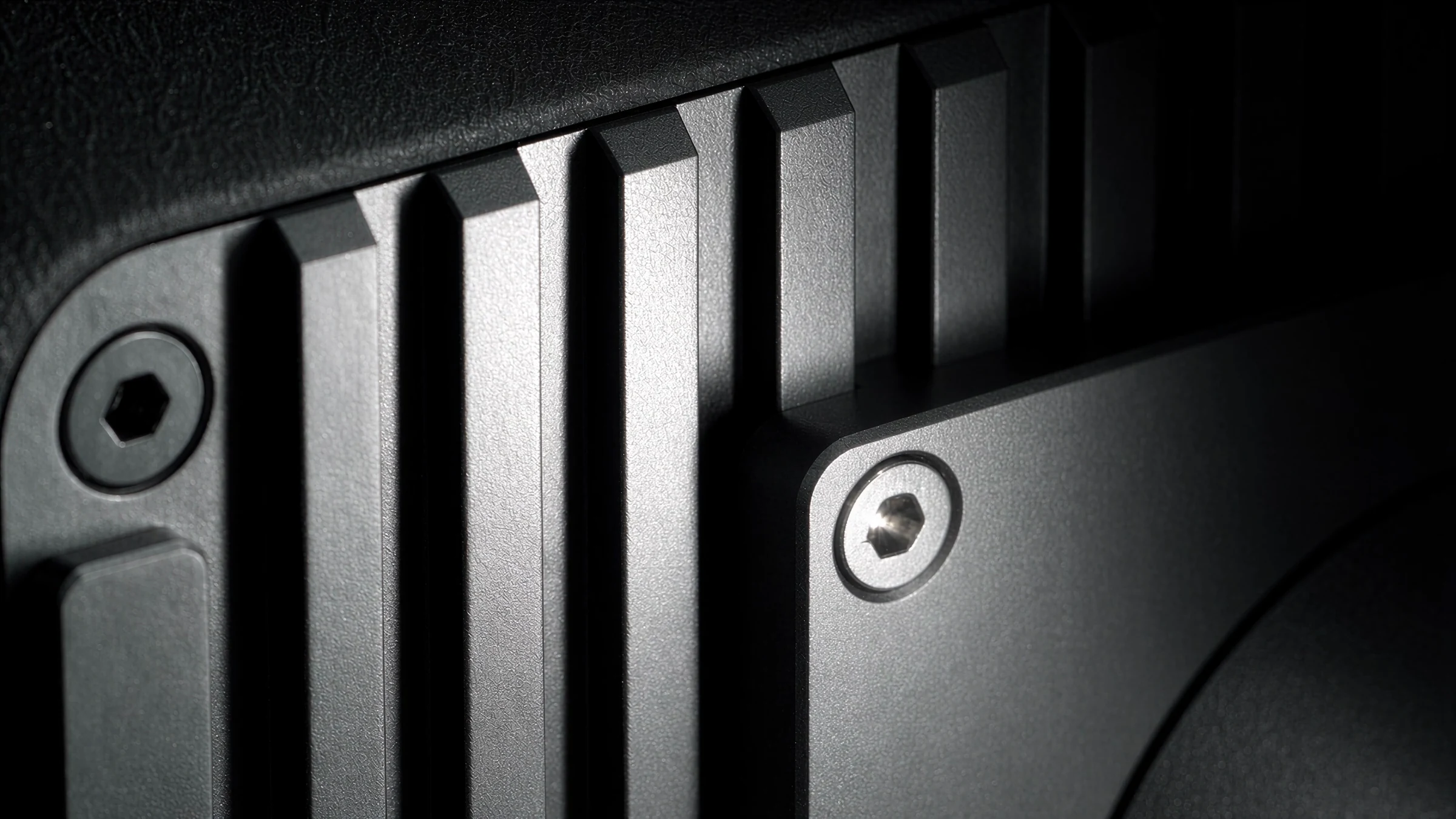 Macro of the aluminium cooling fins and a hex screw on the back of the monitor