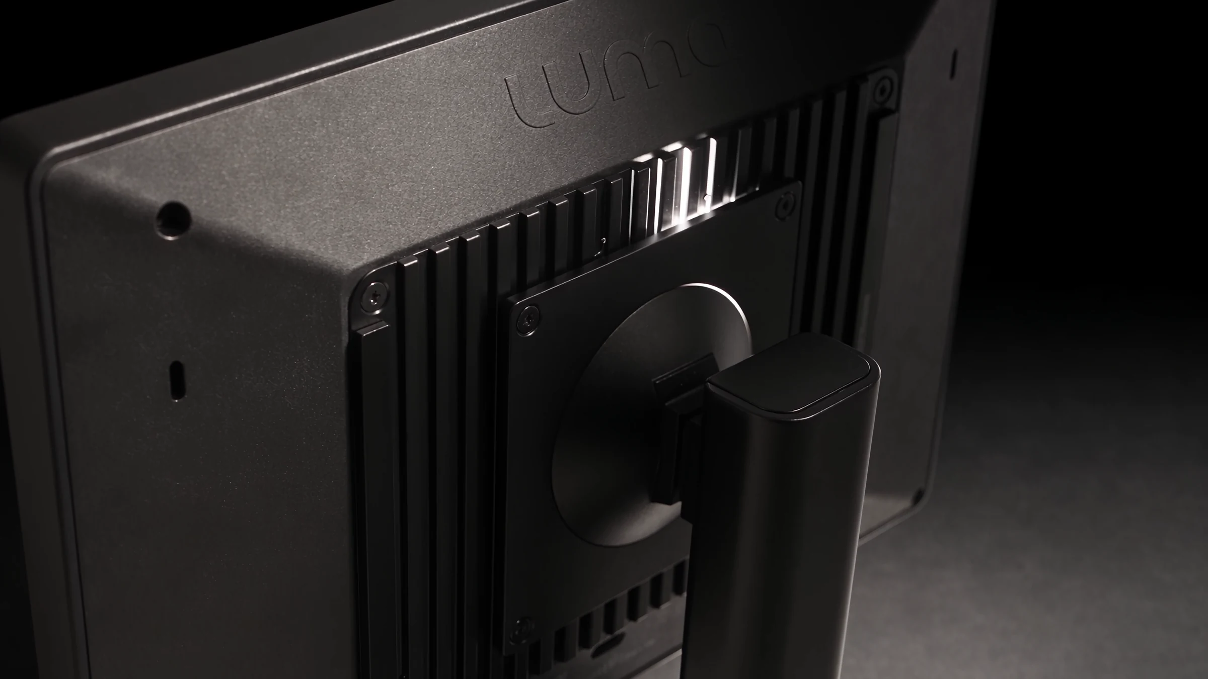 Back of the eye tracker monitor on its stand, lit with a soft side light