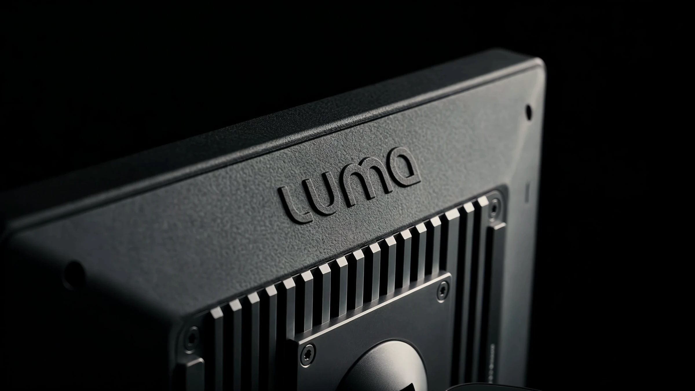 Close-up of the embossed logo above the cooling fins on the back of the eye tracker