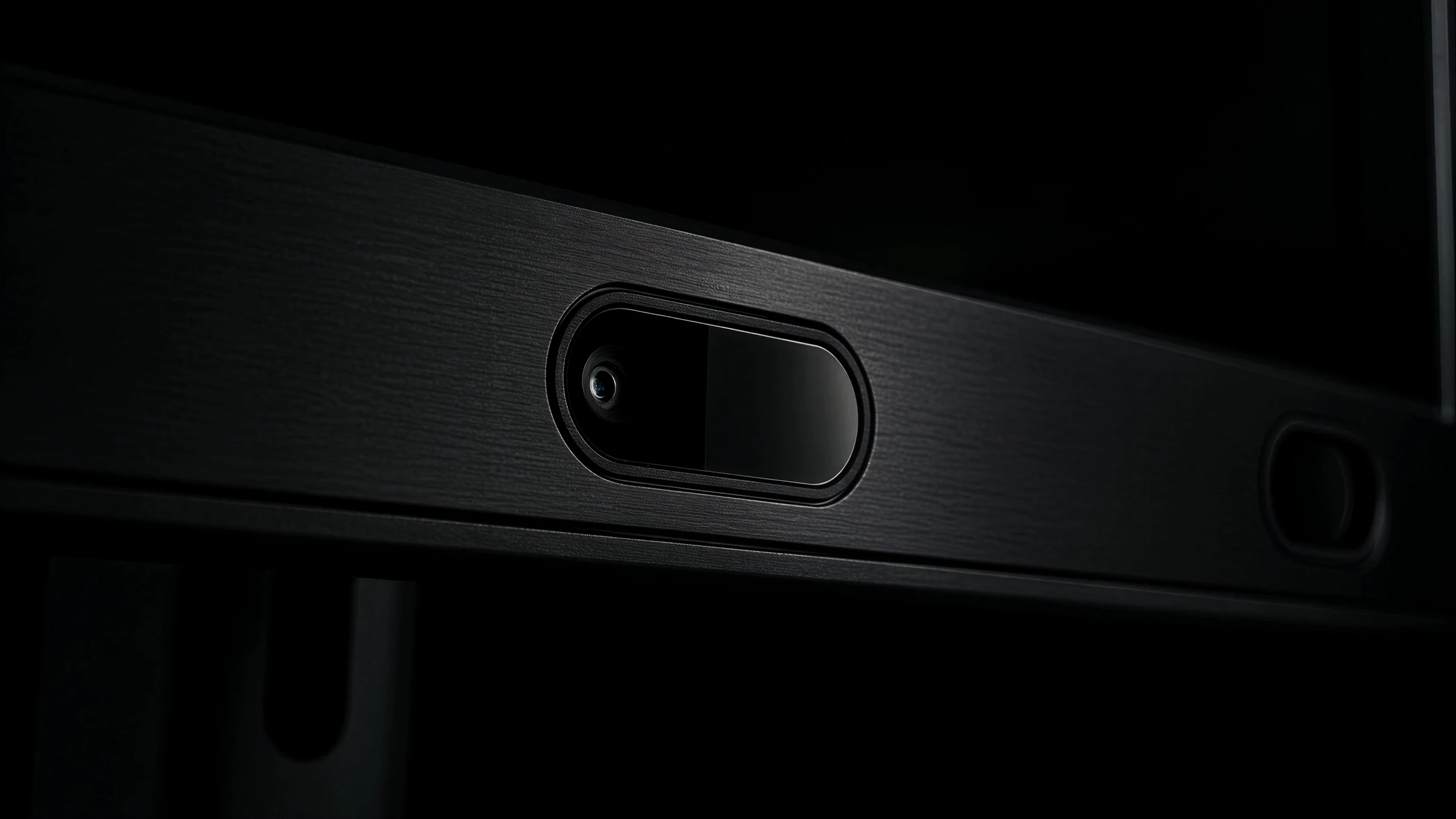 Macro shot of the brushed metal sensor bar and camera lens of the eye tracker
