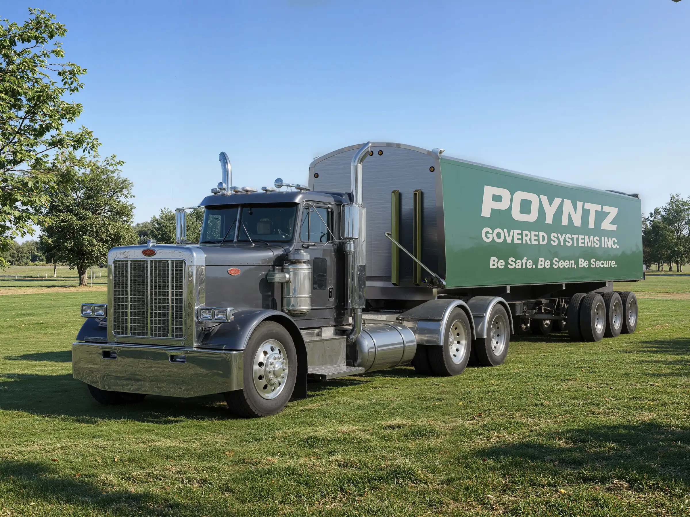 Render of a truck and trailer with the tarp system fully closed and printed with the Poyntz Covered Systems logo