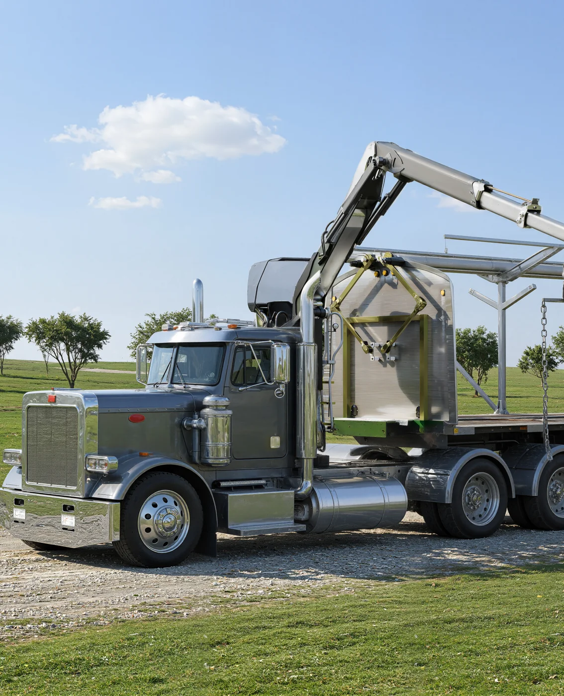 Render of a truck with a mounted crane next to the front bulkhead of a rolling tarp system on a flatbed