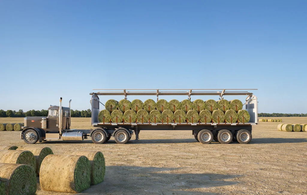 Render of a flatbed truck with an open rolling tarp system loaded with sod rolls