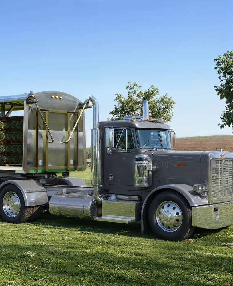 Render of a long-nose truck with a flatbed carrying sod pallets behind the front bulkhead of a tarp system