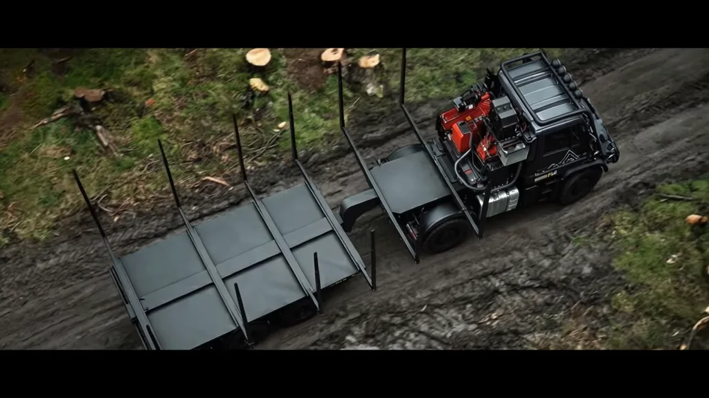 Film still of a loaded logging truck