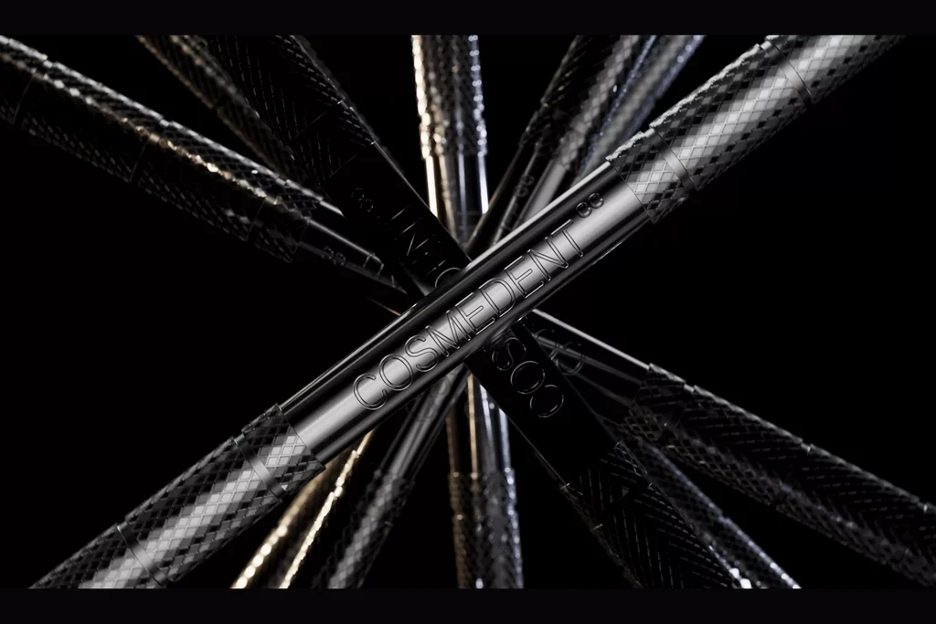 CGI of a set of dental instruments with textured handles crossing on a black background