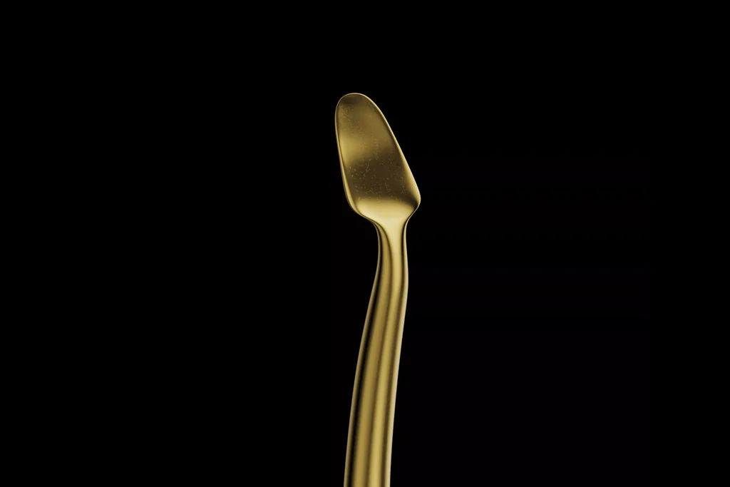 CGI of a gold-coloured dental instrument tip on a black background
