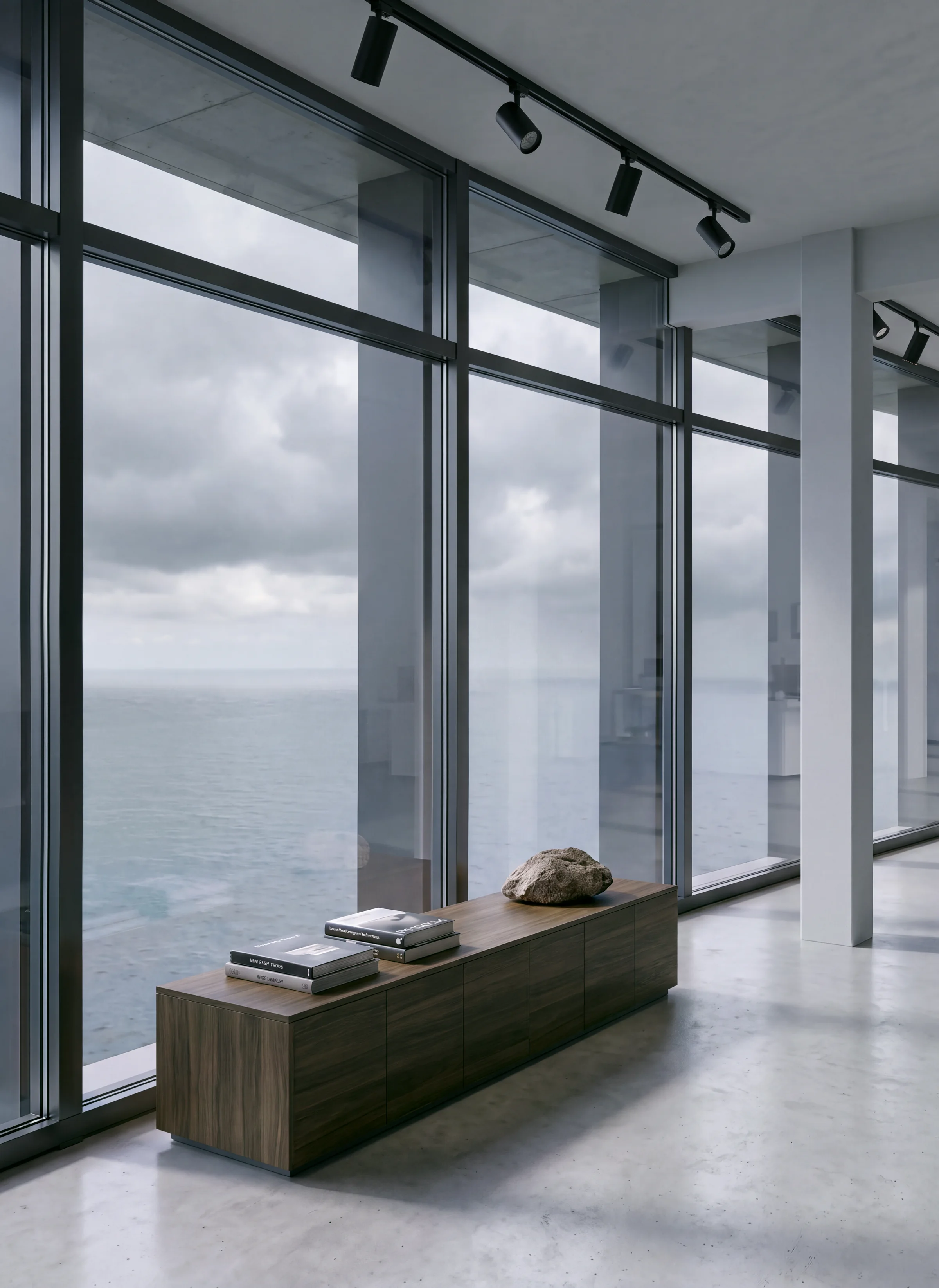 Render vertical de una galería junto a un muro de vidrio con un banco de madera y una muestra de roca, con vistas al mar